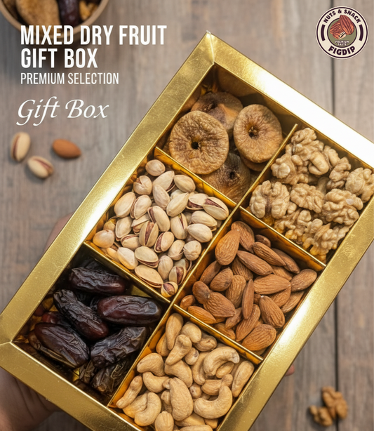 Gold gift box with assorted dried fruits on a wooden surface